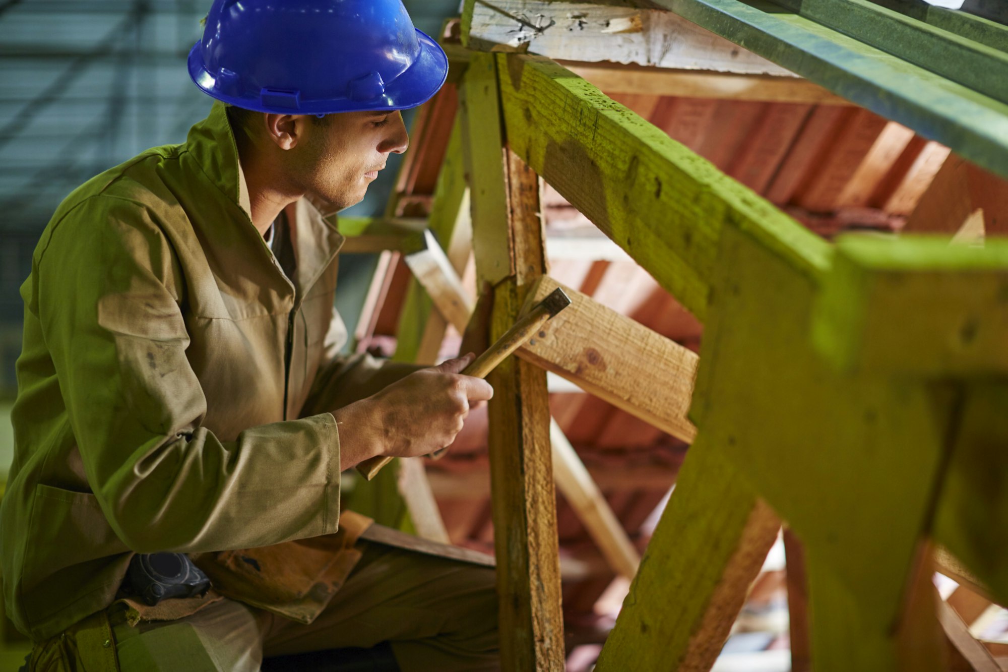 Construction worker working on roof beams